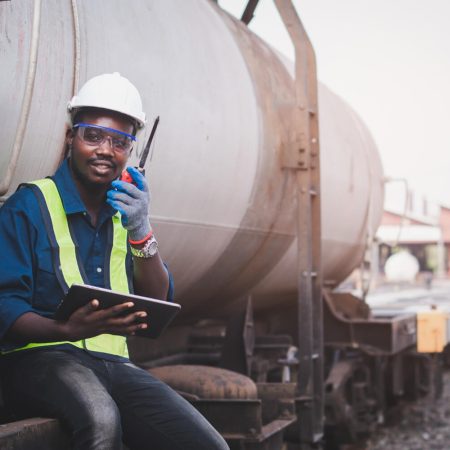african-machine-engineer-technician-wearing-helmet-groves-safety-vest-repair-train-with-using-tablet (1)