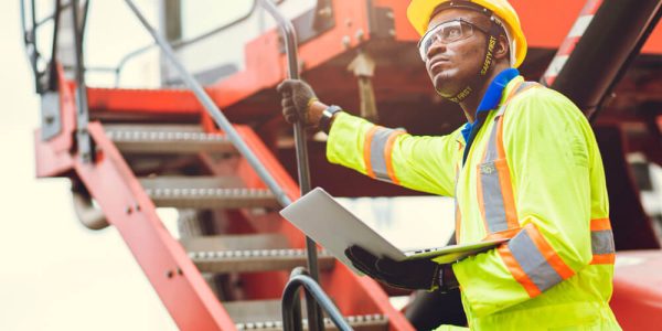 black-african-staff-foreman-intend-work-loading-worker-using-laptop-computer-control-cargo-shipping-logistic-warehouse (1)