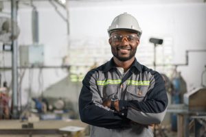 portrait-african-american-male-engineer-uniform-smiling-standing-cross-arm-industrial-factory (1)