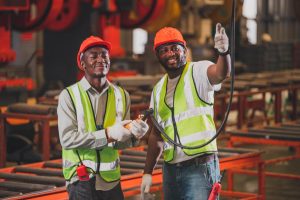 two-people-black-man-african-american-worker-control-heavy-machine-factory (1)